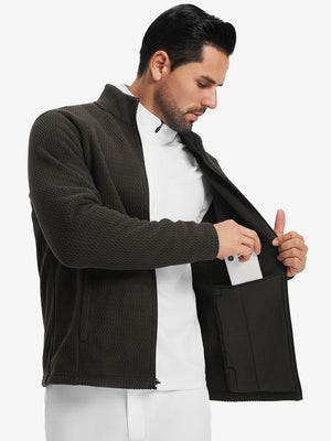 Model showing inner pocket of soft winter fleece jackets in coffee brown, fitting an iPhone inside.