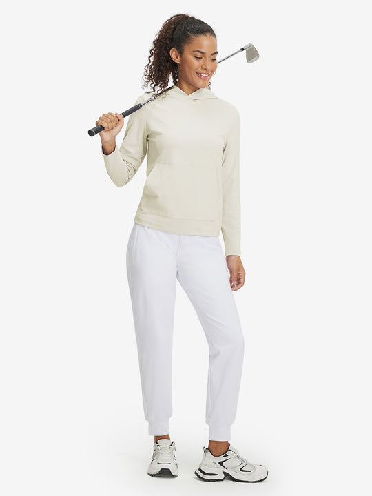 Model holding golf club, dressed in women's lightweight hoodies pullover in cream.
