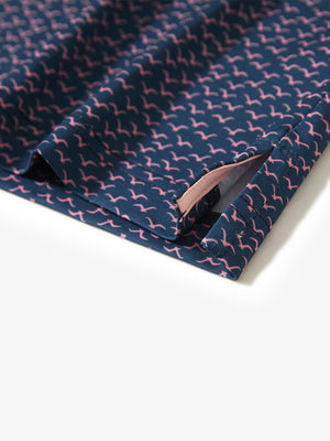 Hem slit detail of the navy pink seagull lightweight print long sleeve polo, showing fine stitching and finish.