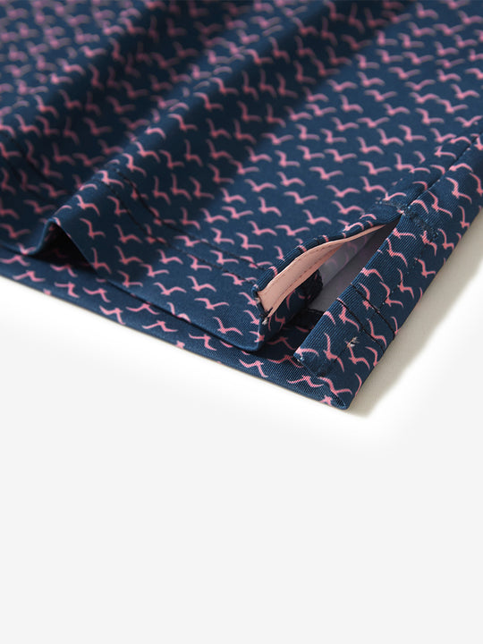 Hem slit detail of the navy pink seagull lightweight print long sleeve polo, showing fine stitching and finish.