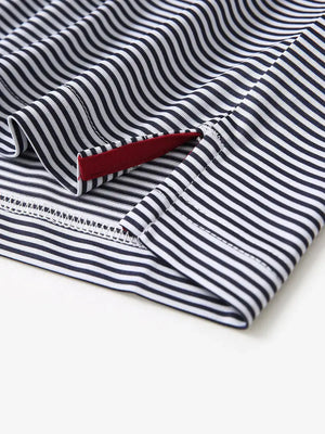 Detailed view of side hem slit on Cooling Stripe Golf Shirt in NAVY STRIPE, showing comfort and design