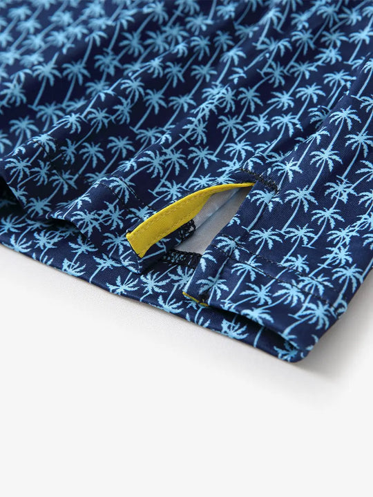 Showcasing a navy blue palm tree pattern model polo shirt corner opening, the perfect combination of tropical flavor and golf game, details show exquisite and comfortable.
