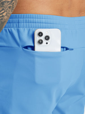 Back pocket detail of Water Resistant Comfy Fleece Golf Joggers in sky blue, holding smartphone