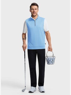 Front full body shot of model wearing light blue melange lightweight sleeveless quarter zip golf vest, holding a golf club in one hand and carrying a basket of golf balls in the other hand