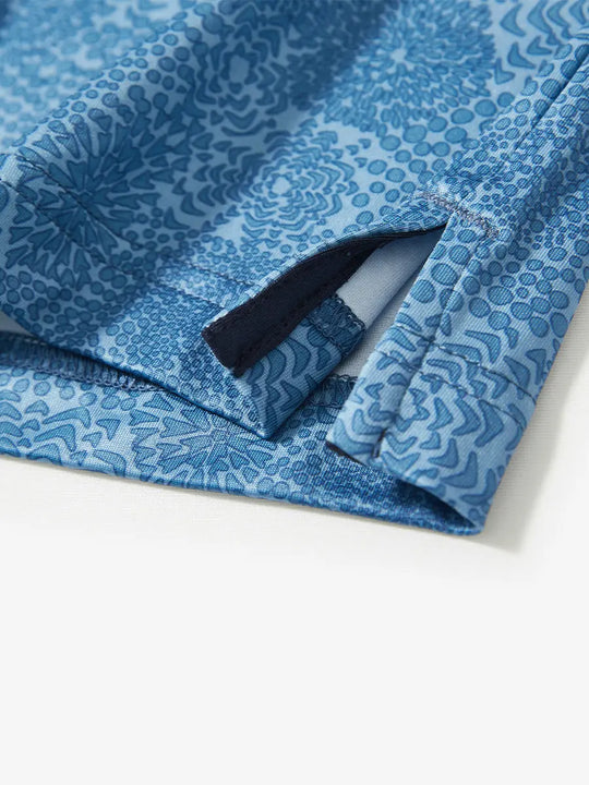Detail view of the midnight fireworks pattern polo, emphasizing the clean hem opening and festive style.