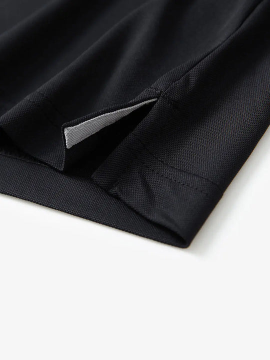 Detail shot of hem opening on BLACK Ventilated Pique Performance Polo