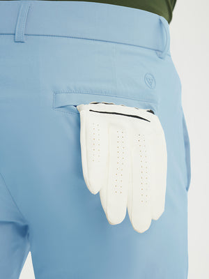 Close-up of the back pocket detail on the light blue stretch soft flat front dress golf shorts, emphasizing storage