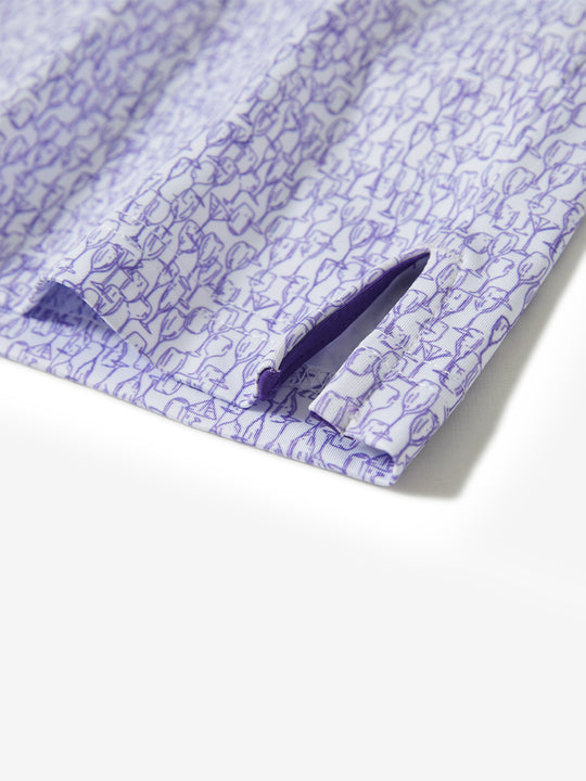 Hem slit detail of the purple wine glass lightweight print long sleeve polo, showing fine stitching and finish.