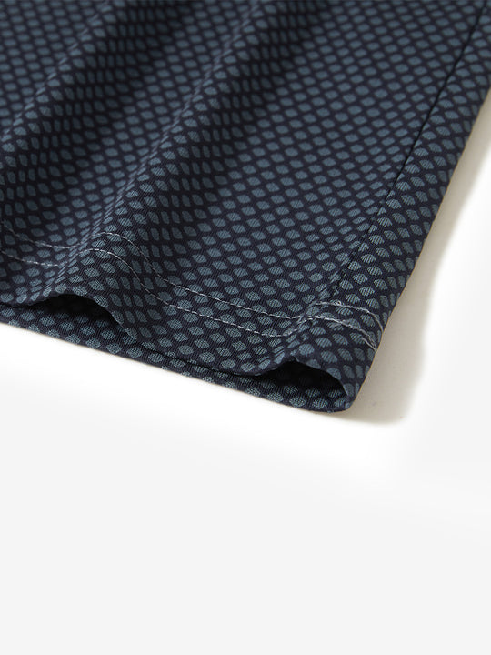 Hem detail of jacquard quarter zip pullover in grey/navy, focusing on stitching and side vent finish.