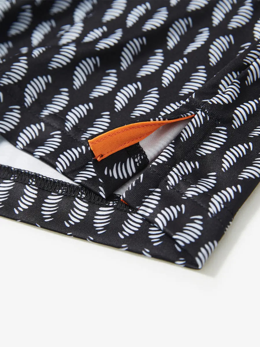 Hem slit detail of BLACK WHITE TWISTER Performance Quick Dry Print Golf Polo highlighting stitching and finish