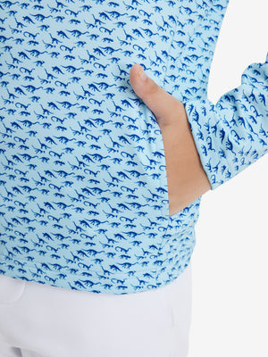 Model with both hands in pockets wearing youth full print stylish hoodies pullover in blue dinosaur.