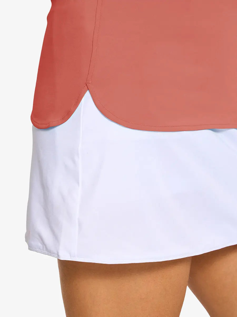 Detail shot of side hem opening on CORAL PINK Women's Performance Solid Polo