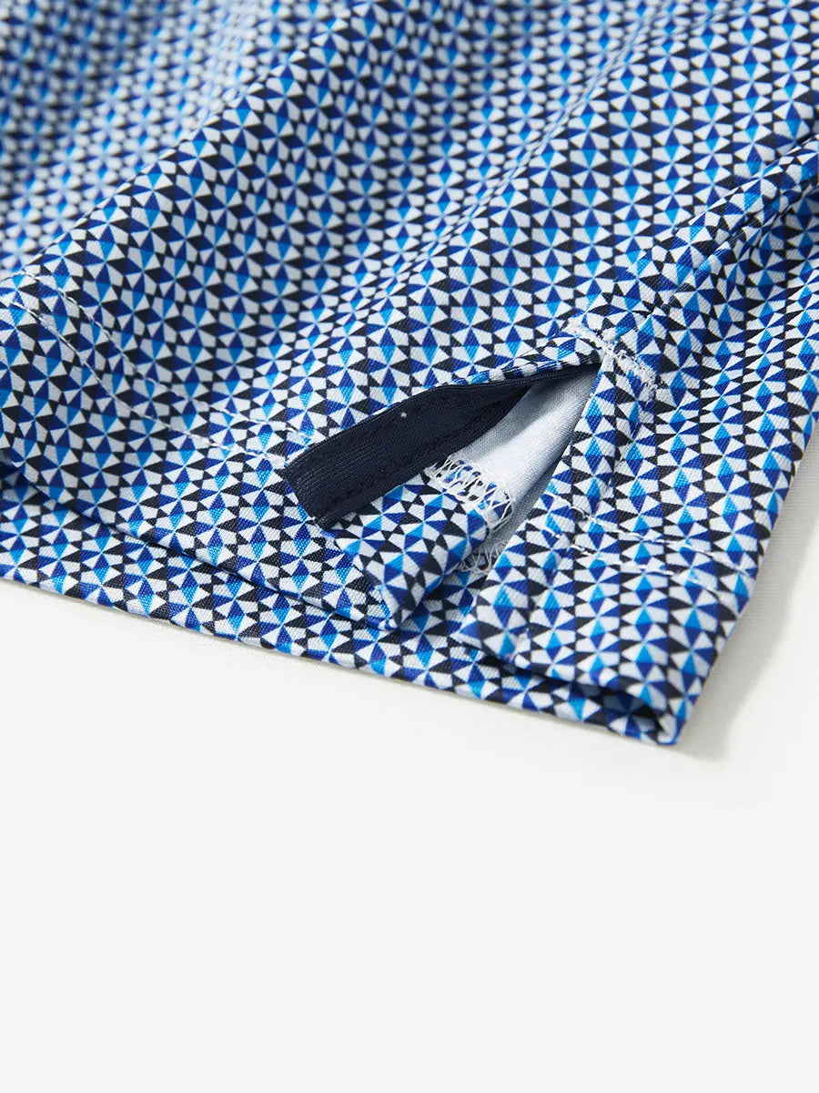 Detail view of the bluish umbrella pattern polo, focusing on the elegant hem opening and smooth fabric