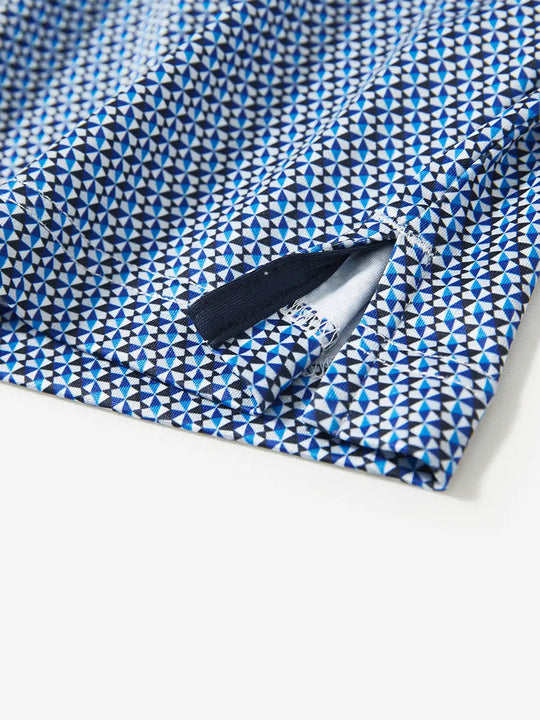 Detail view of the bluish umbrella pattern polo, focusing on the elegant hem opening and smooth fabric
