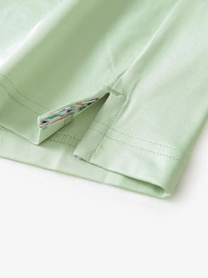 Close-up of side slit detail on the Canary Green Everyday Classic Solid Polo hem