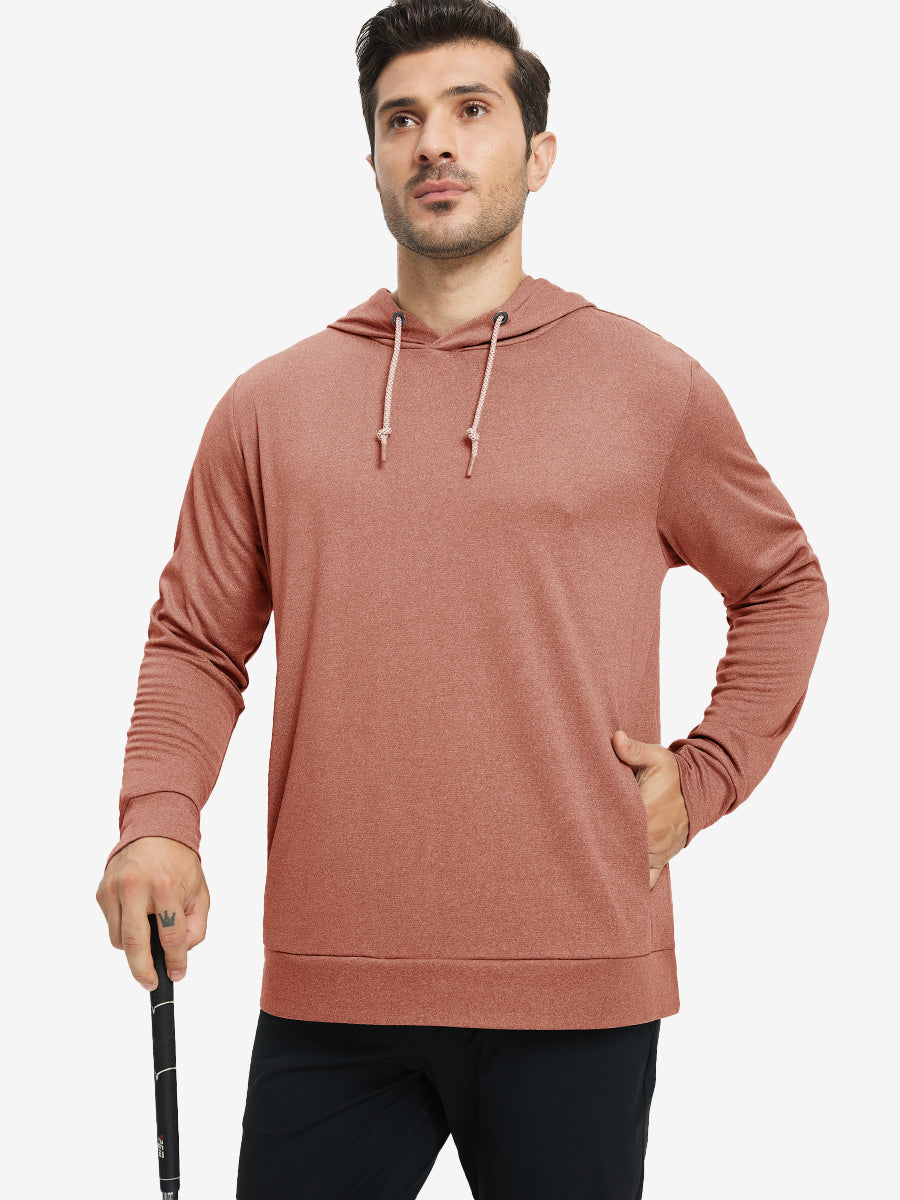 Model with one hand in pocket, wearing classic heather pullover hoodie in brick melange, relaxed look.