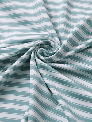 Close-up of haze blue whiteyarn dyed stripe polo fabric showing distinct woven stripes and textured surface.