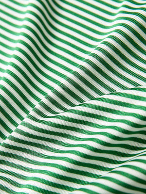 Texture close-up of Kids stripe golf polos with soft fabric and bright emerald stripe stripes
