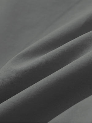 Close-up of dark grey boys lightweight dry fit flat front golf shorts fabric texture.