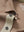 Detail shot of the collar on the light brown ventilated pique performance polo, emphasizing the classic neckline design