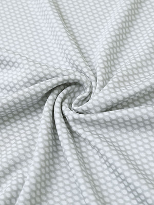 Close-up of light grey your favorite jacquard polo fabric showing textured knit and soft finish.