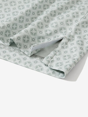 Detail: hem slit of gray geometric stretch printed collarless henley golf shirts.