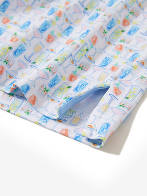 Close-up of the hem vent on the colorful wine glass 4 way stretch print collared polo shirt, showing the side split for movement