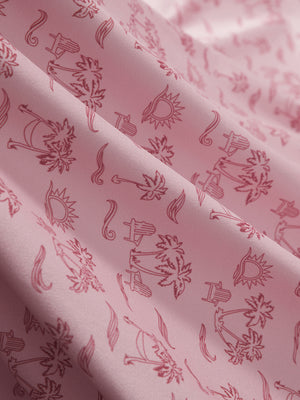Close-up of pink beach palm stretch printed collarless henley golf shirts, showcasing texture and print details.