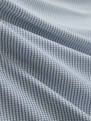 Close-up of white light blue grid ultra-light quick dry moisture wicking collared polo shirt fabric texture