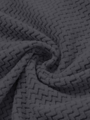 Fabric close-up of warm stretchy quarter zip with pocket, smooth knit texture and flexible feel in grey