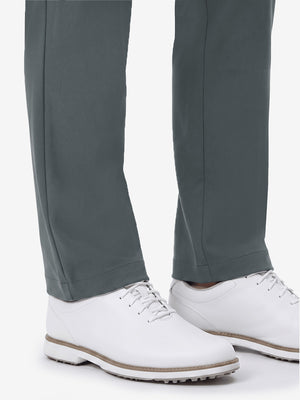 Detail view of hem and lower leg on dark gray women's regular fit stretchy golf pants