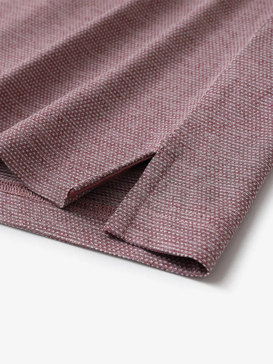 Close-up of side hem slit on Ventilated Heather Jacquard Polo in DUSTY ROSE HEATHER, showing detail