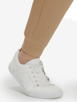 Detail view of hem on light khaki  flat front golf joggers pants with belt loops