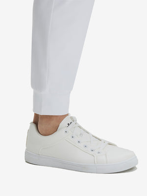 Detail view of hem on white flat front golf joggers pants with belt loops