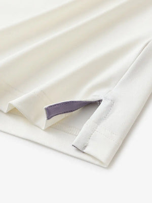 Close-up of hem slit detail in CREAM Premium Performance Polo