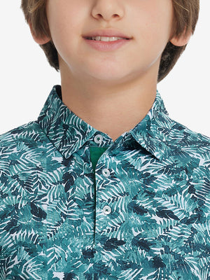 Front view of youth wearing dark green leaf performance print boys golf polo, showing collar and chest fit