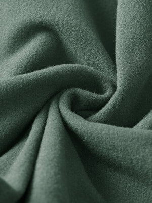 Fabric close-up of forest green boys stretch fleece lined casual golf pants, soft stretch fabric with warm fleece lining.