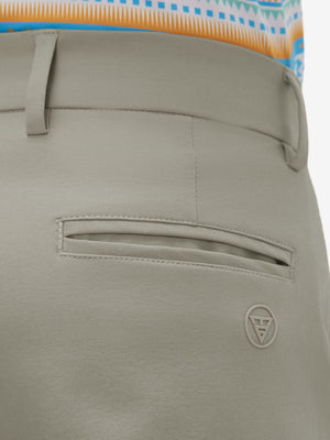 Close-up of the back pocket detail on the khaki grey youth water resistant cotton blend golf pants, emphasizing storage