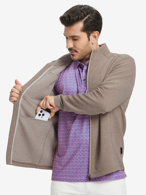 Model front half body lifting jacket, hand in inner pocket, textured insulated winter jacket, light brown heather.