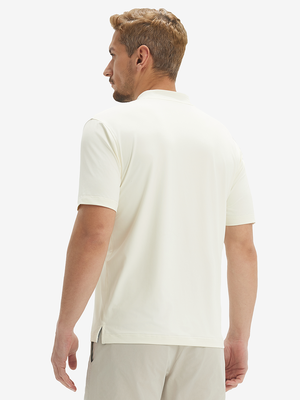 Side-back half-body view of model in cream moisture-wicking short sleeve henley shirt