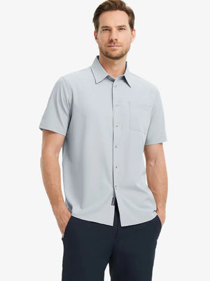 Half-body front view holding a golf club, wearing the GLACIER GREY polo on the course.