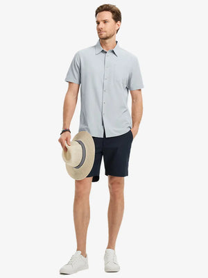 Detail shot with model holding a cap, featuring the GLACIER GREY polo’s side vent.