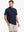 Half-body front view holding a golf club, wearing the NAVY polo on the course.