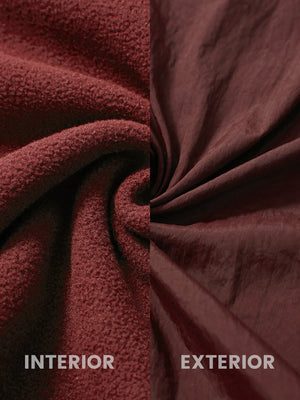 Close-up of inside and outside fabric of maroon windproof fleece reversible golf vest.
